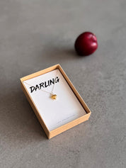 Heart-shaped necklace on a 'Darling' message card in a gift box.